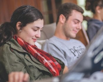 Students sitting on couch while studying