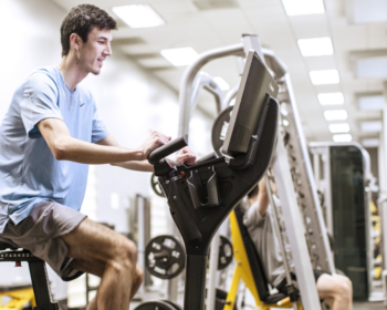 man using an exercise machine in the gym
