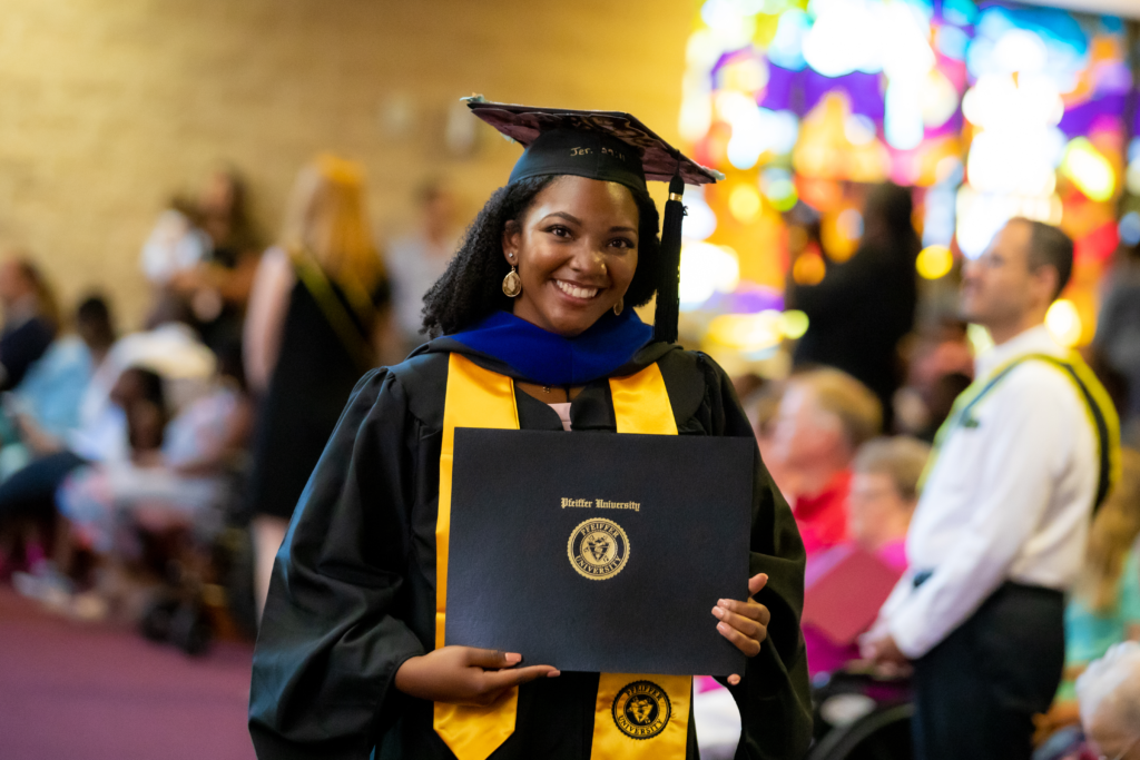 Female graduate smiling holding degree