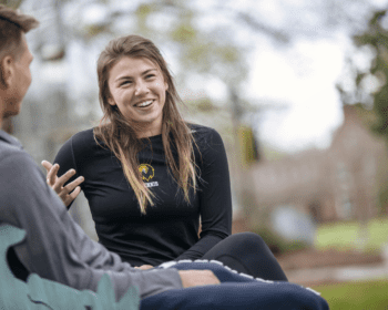 woman smiling and talking sitting outside
