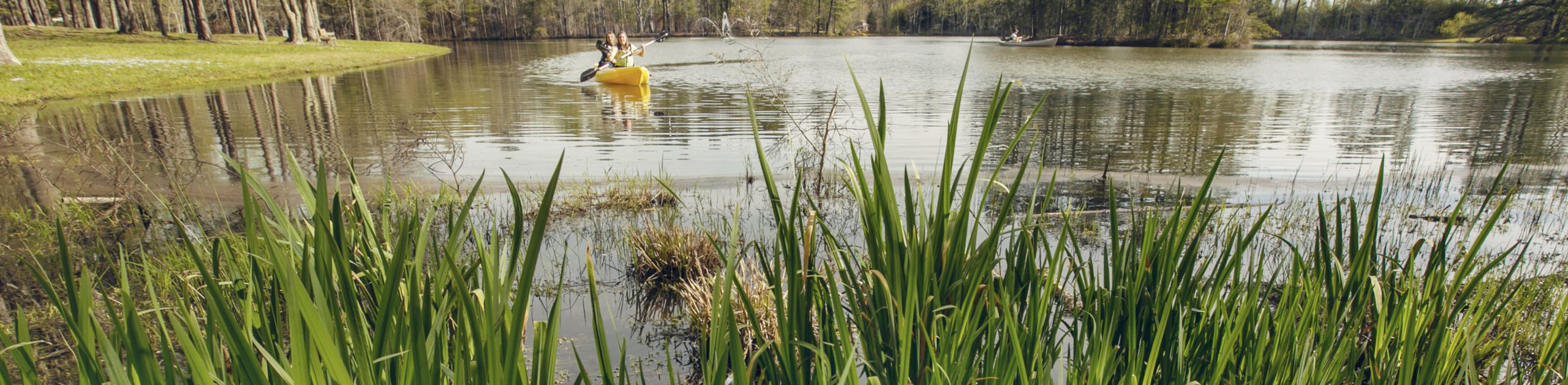 Two students kayaking on a lake