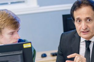 professor talking to students in computer lab