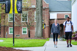 two students walking outside on campus