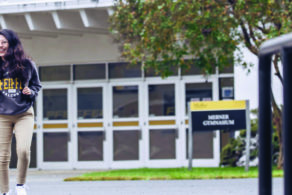 three female students walking outside on campus