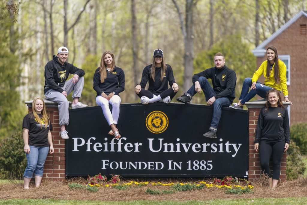 Students sitting around Pfeiffer sign