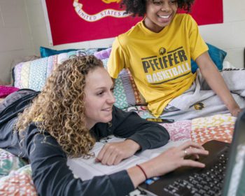 Two female students studying in dorm