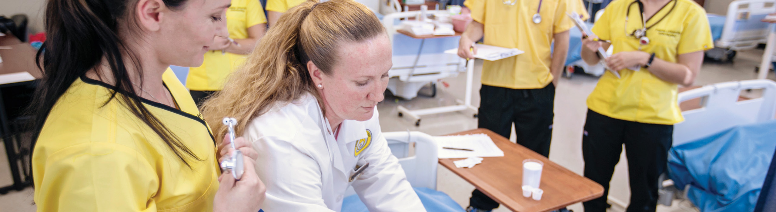 Nursing instructor and students in lab
