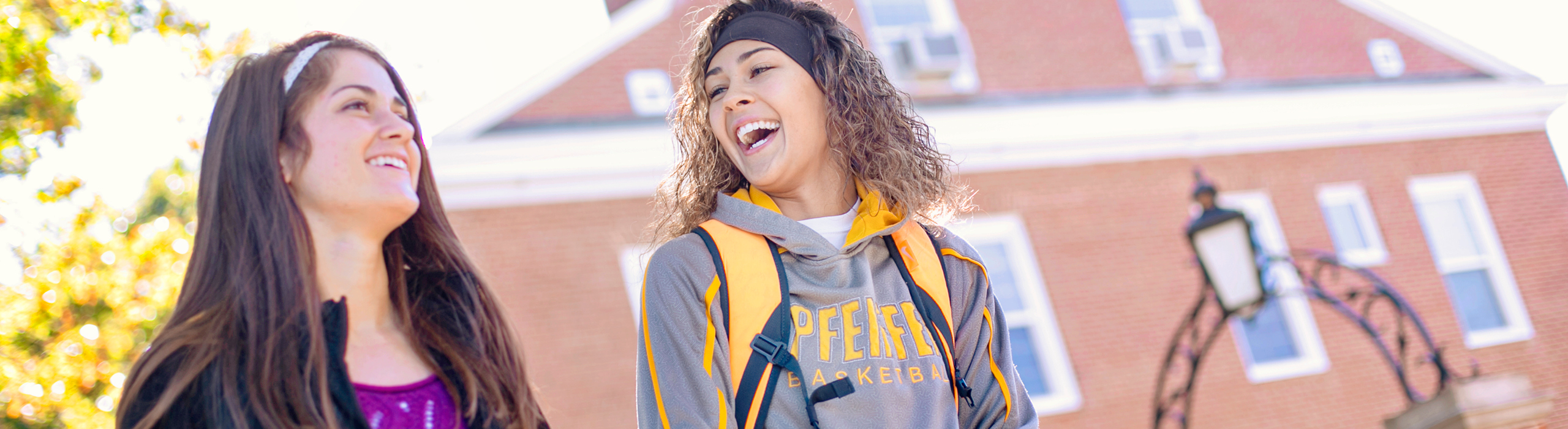 Students walking and talking outside and laughing